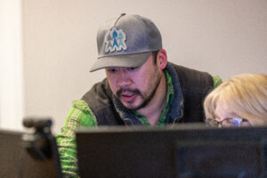 Mitch at ESL Group working with staff on project